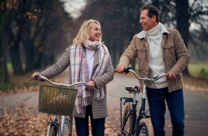 happy couple in forest with bikes